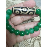 Tibetan 9 eye dzi bead turtle back with green jade bracelet .