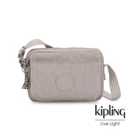 【KIPLING】溫柔燕麥色前後加寬收納側背包-ABANU