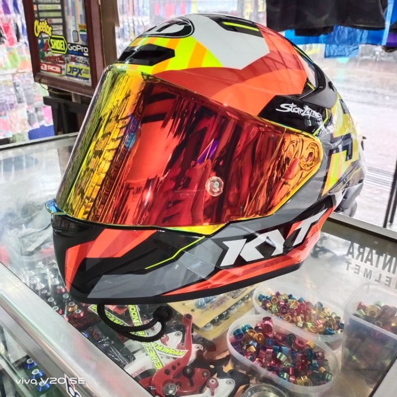 red and gold motorcycle helmet